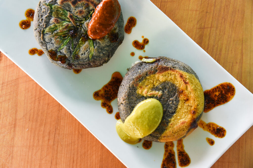 Gorditas on a plate, topped with salsa