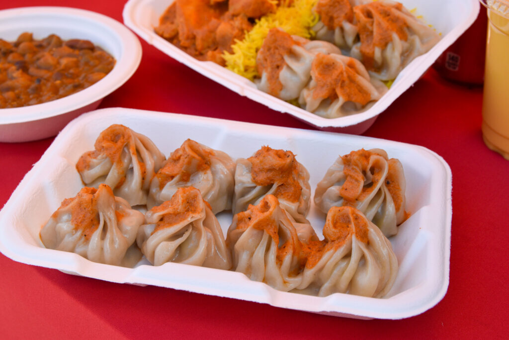 Vegan dumplings topped with an orange sauce