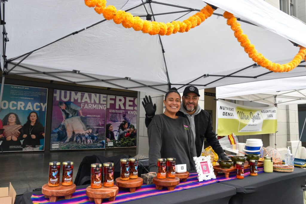 Janeen and Rodrigo pose at Kuali's stand at the Ferry Plaza Farmers Market