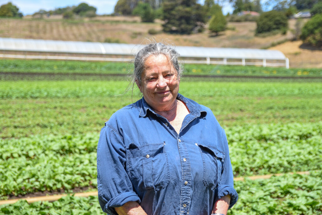 Annabelle Lenderink, posing in front of a green field at Star Route Farms