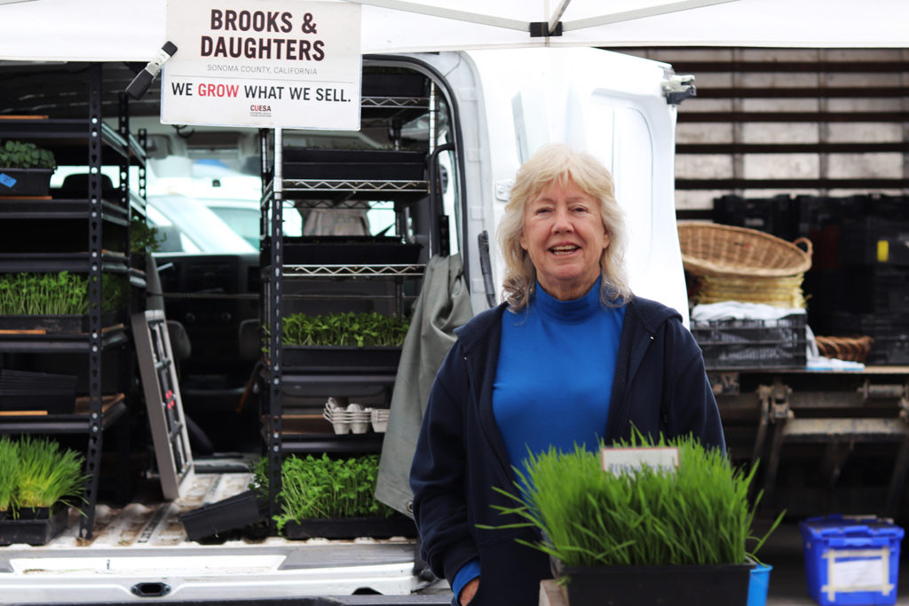 Corie Brooks poses at Brooks and Daughters stand at the Ferry Plaza Farmers Market in San Francisco.