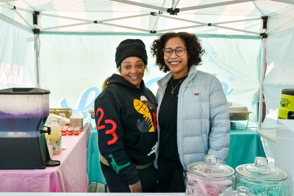 Two people pose at Lil' Alijo's stand at Foodwise's Pop-Ups on the Plaza event at the Ferry Plaza Farmers Market in San Francisco