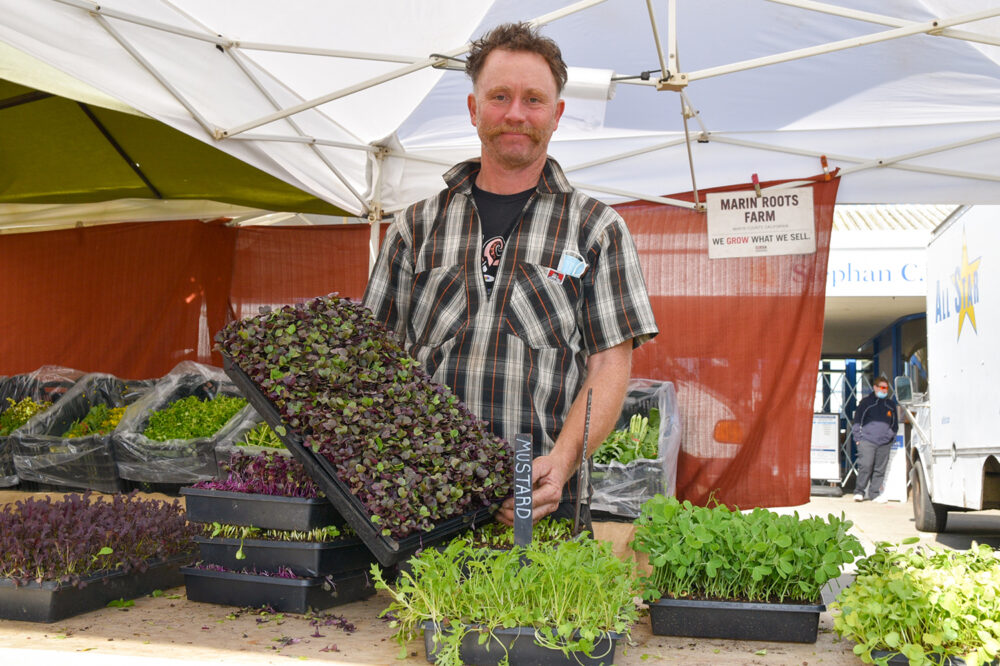 Jesse at Marin Roots Farm's stand at FPFM