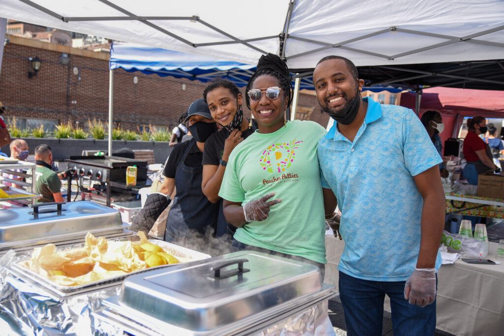 Three people pose at Peaches Patties stand at Foodwise's Pop-Ups on the Plaza event at the Ferry Plaza Farmers Market in San Francisco