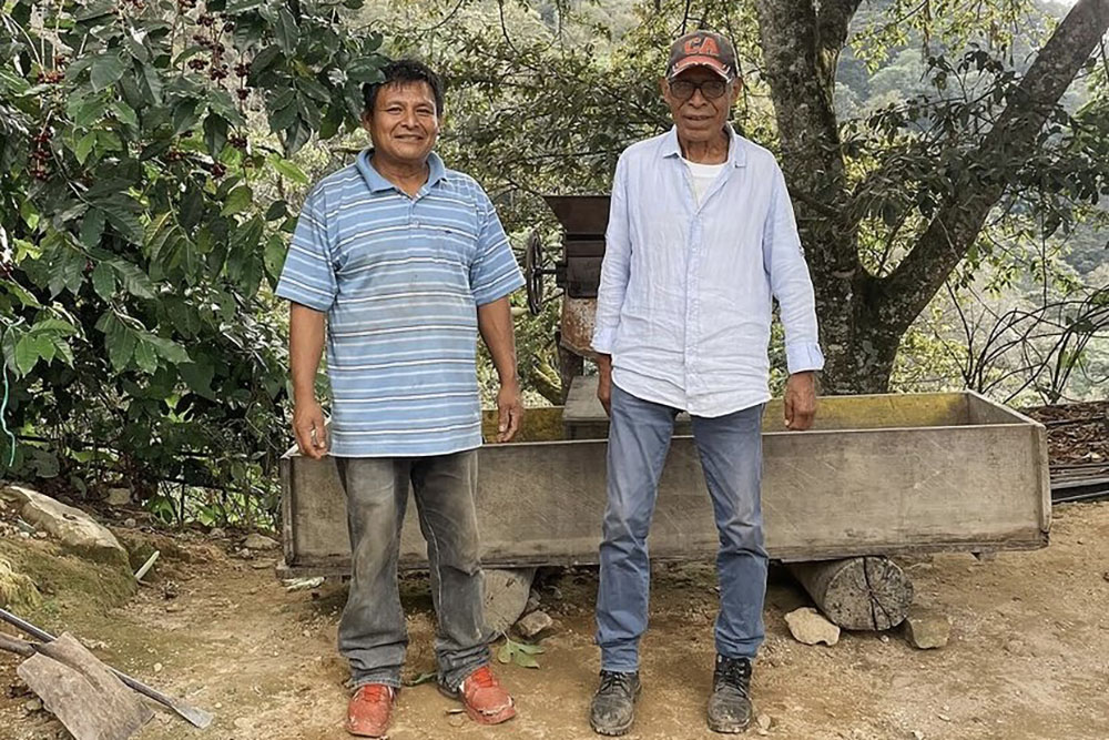 Two people, Saul and Raymundo, pose on their small coffee farm in Oaxaca, Mexico