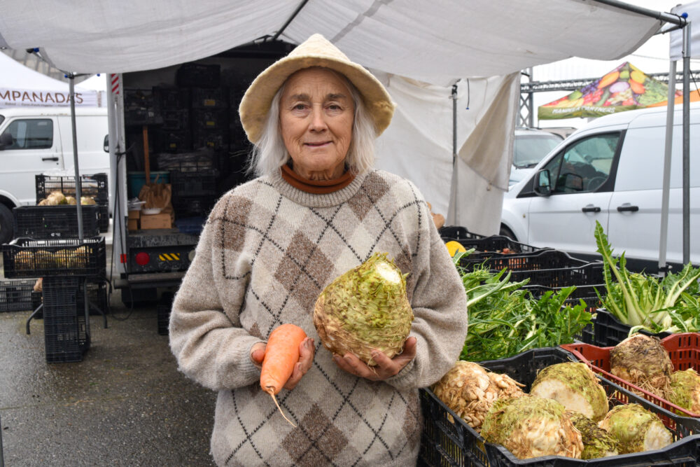 Lee holds celeriac and a carrot at Tierra Vegetables' stand at Foodwise's Ferry Plaza Farmers Market