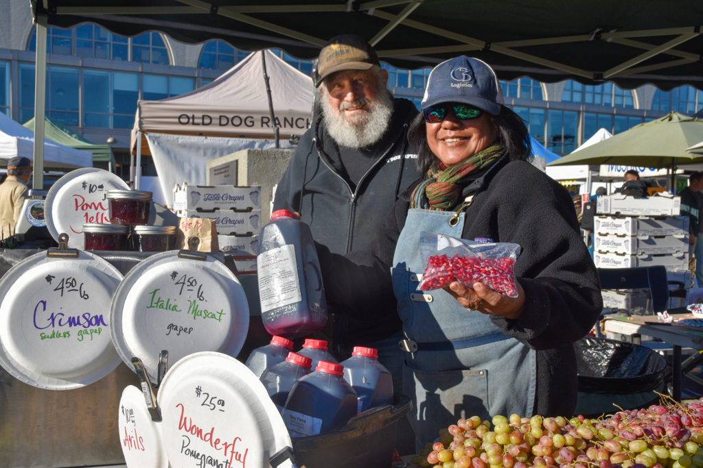 Torosians holding pomegranate products