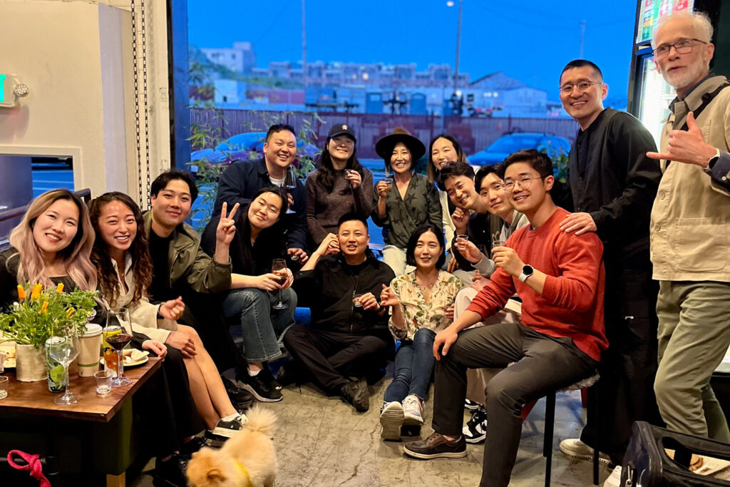 A group poses for a photo inside Volcano Kimchi's Clubhouse, on the list of Asian-owned stores to visit