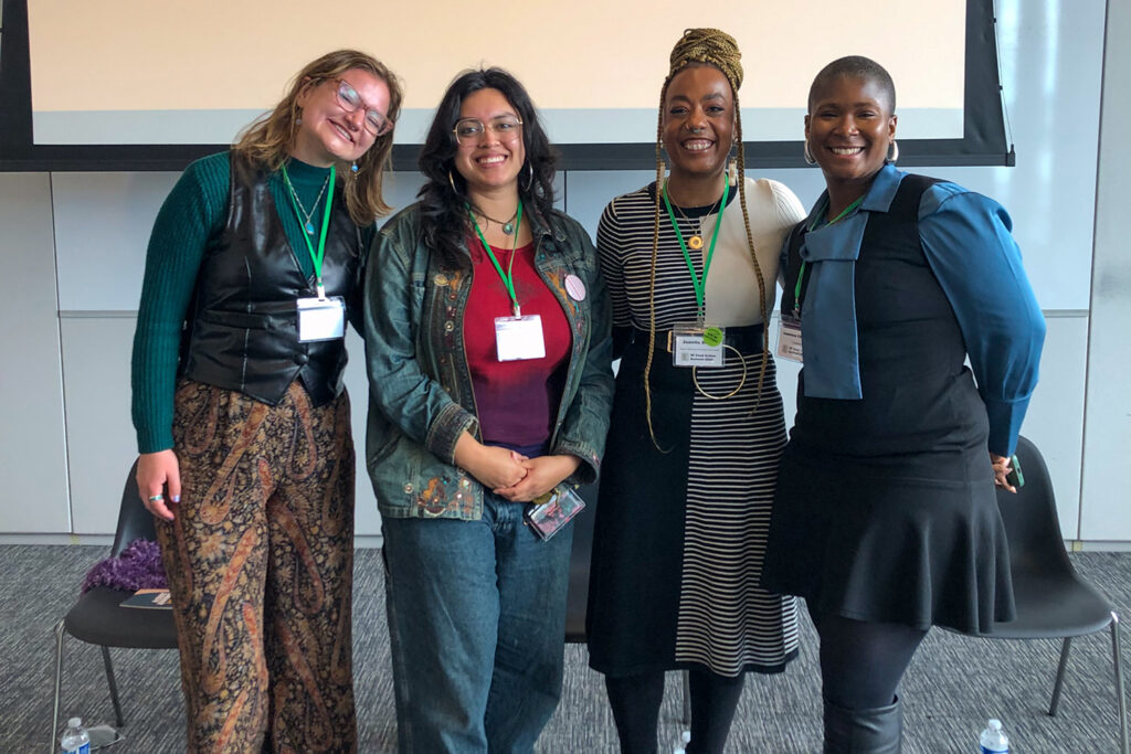 Four people pose for a picture after a Liberation Leaders panel discussion