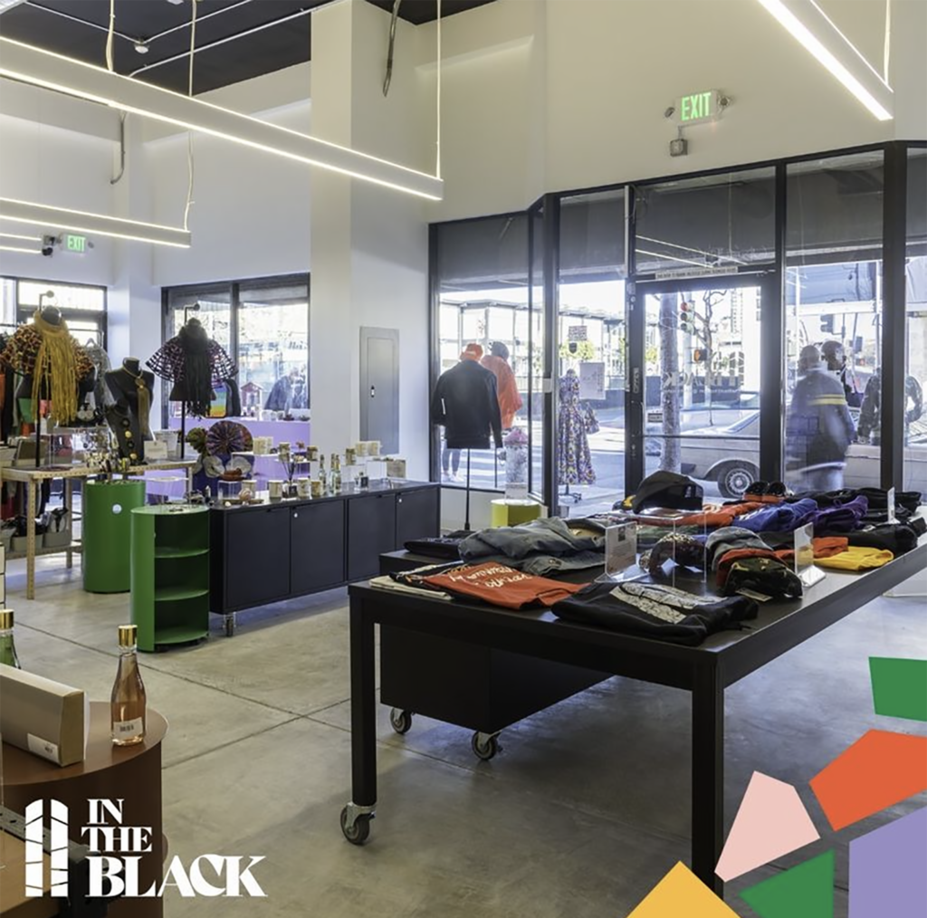 Tables of colorful merchandise inside In The Black Marketplace in the Fillmore District of San Francisco. 